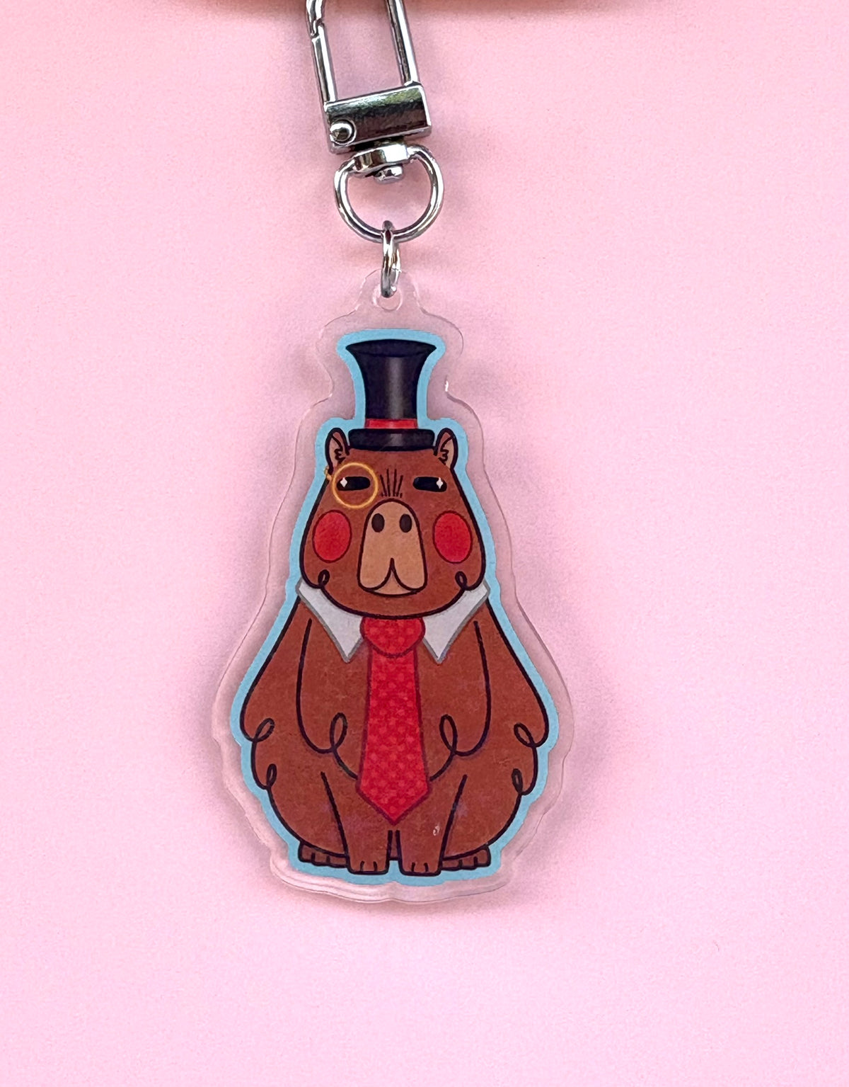 Dappy-Bara Holographic Keyring - acrylic charm featuring a capybara in a top hat, monocle and red tie