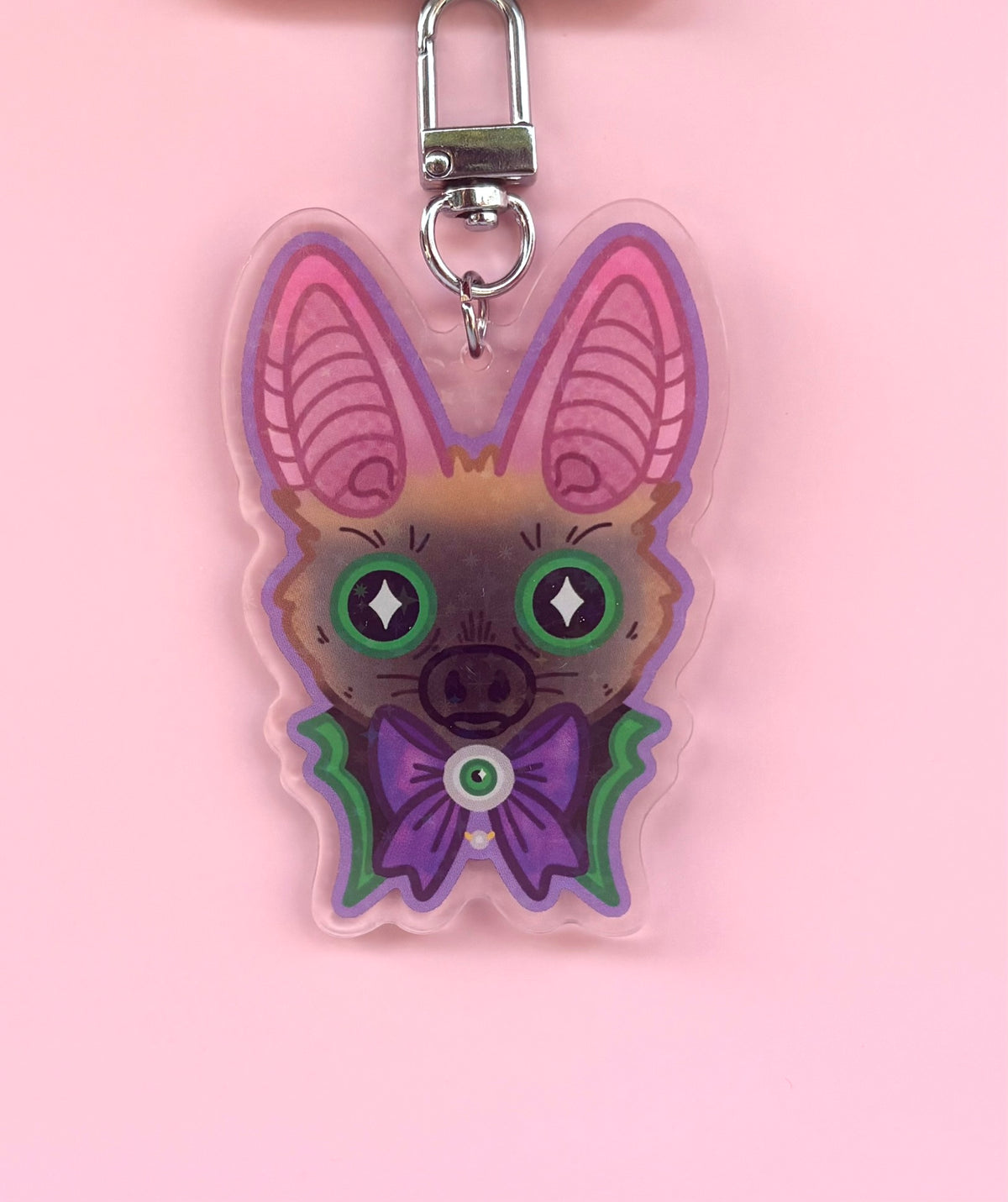 Gothic Bat Holographic Keyring - acrylic charm featuring a cute bat with green eyes and purple bow tie