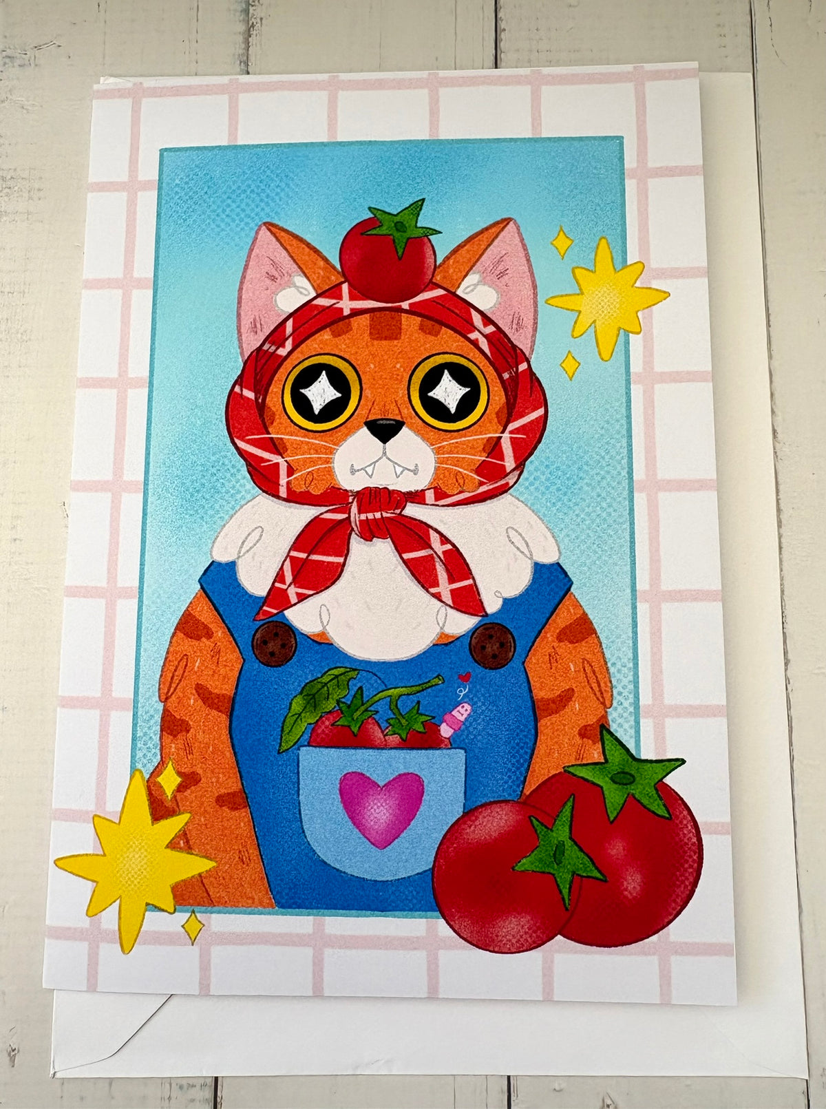 Tomato Dungaree Cat Greetings Card flat with envelope showing ginger cat in dungarees with tomatoes