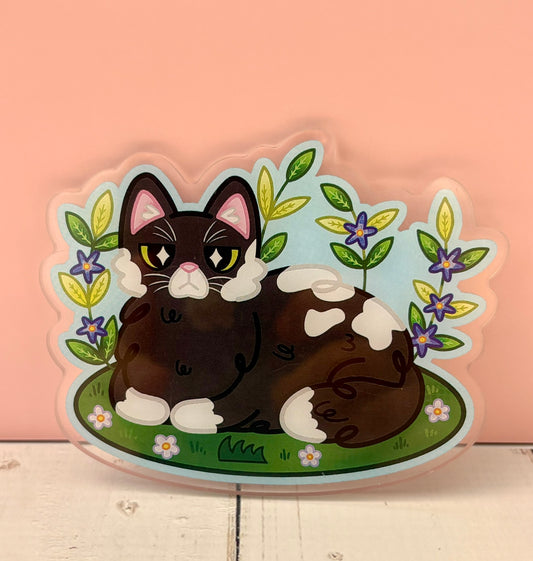 Cozy Garden Cat Pin - finished version featuring a tuxedo cat loafing in a garden with purple flowers