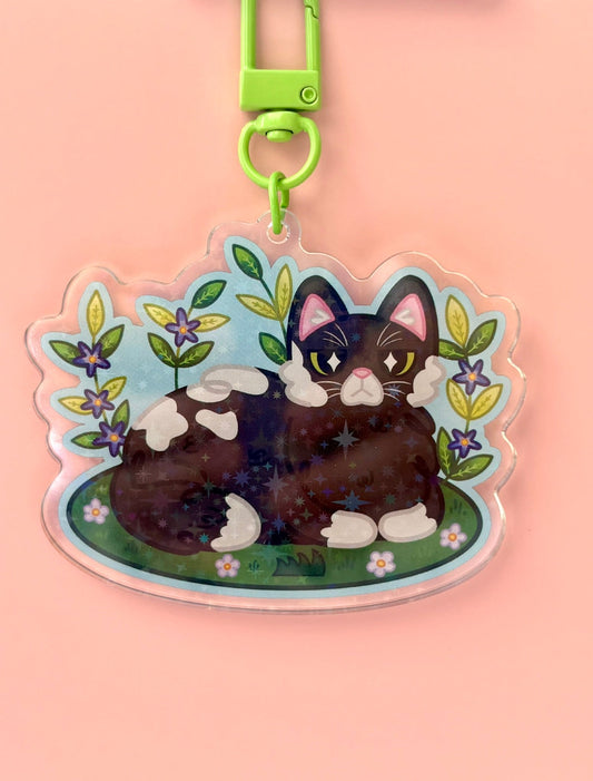Garden Cat Holographic Keyring - tuxedo cat surrounded by flowers and leaves on a holographic acrylic charm
