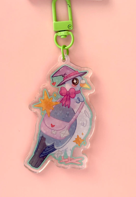 Holographic Witchy Carrier Pigeon Keyring - blue-grey pigeon in a witch hat with a pink bow and letter satchel surrounded by sparkle stars