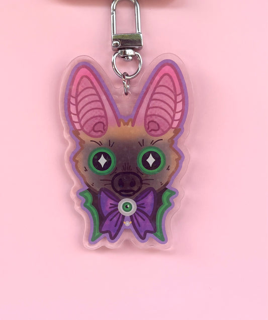 Gothic Bat Holographic Keyring - acrylic charm featuring a cute bat with green eyes and purple bow tie