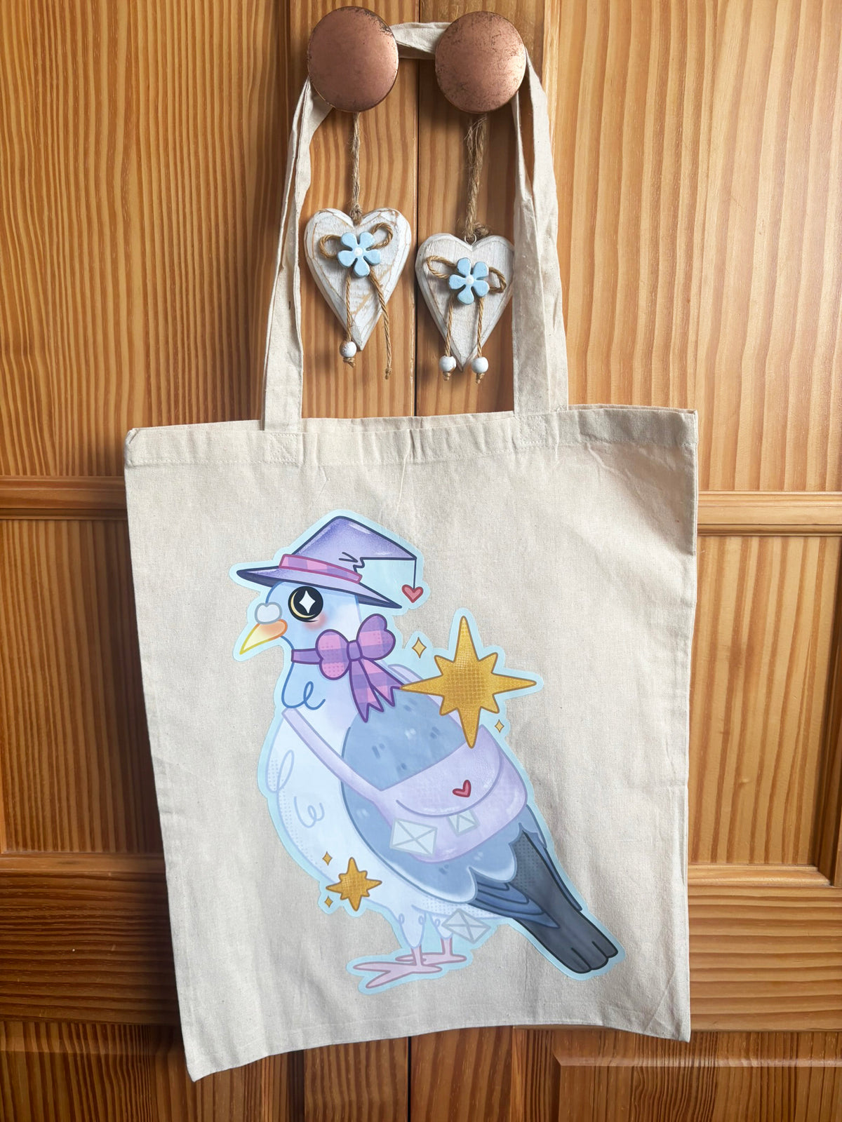 Cream Witch Carrier Pigeon tote bag with long handles and a pigeon in a purple witch hat
